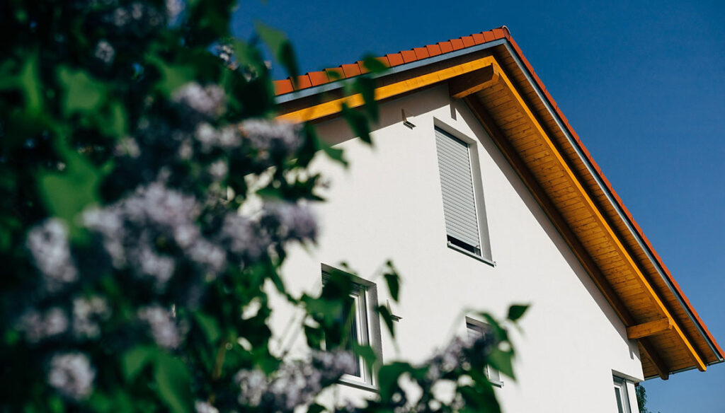 Foto von einem Hausgiebel von unten fotografiert mit einem wolkenfreien blauen Himmel